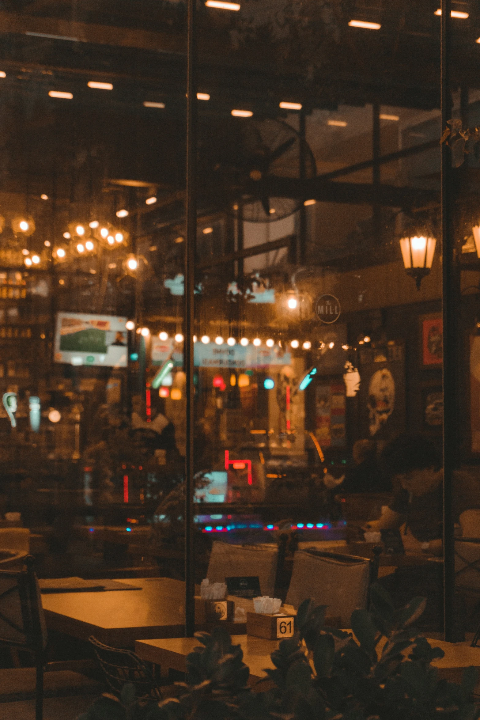 a restaurant's large window with lights reflected in it