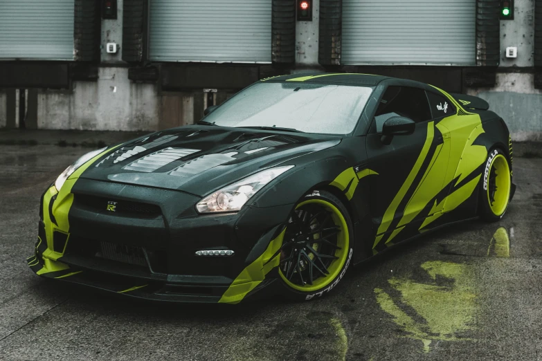 a green sports car parked in front of two buildings