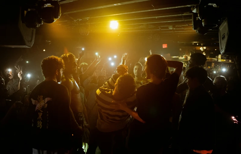a large crowd in a dark room with lights