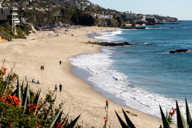 the beach is crowded with people and clear water