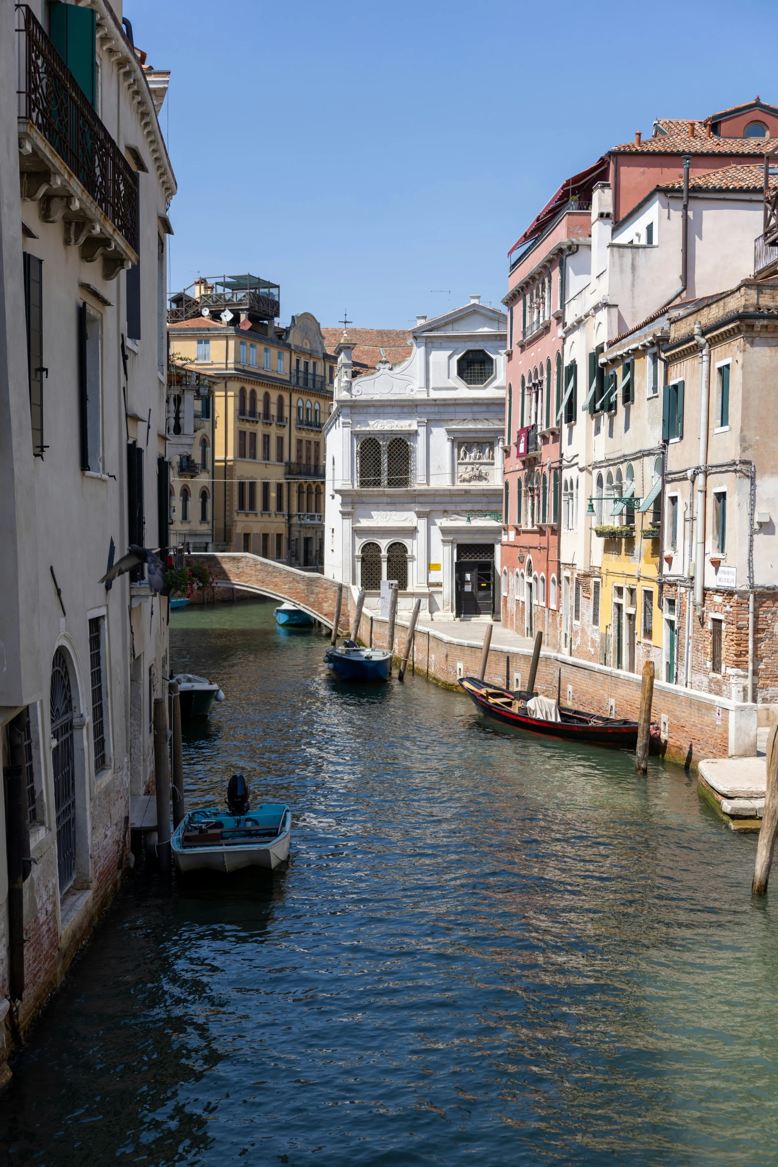 a boat sits in the middle of an old canal