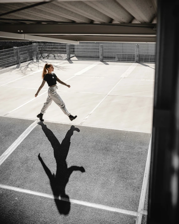 a woman is running across the parking lot