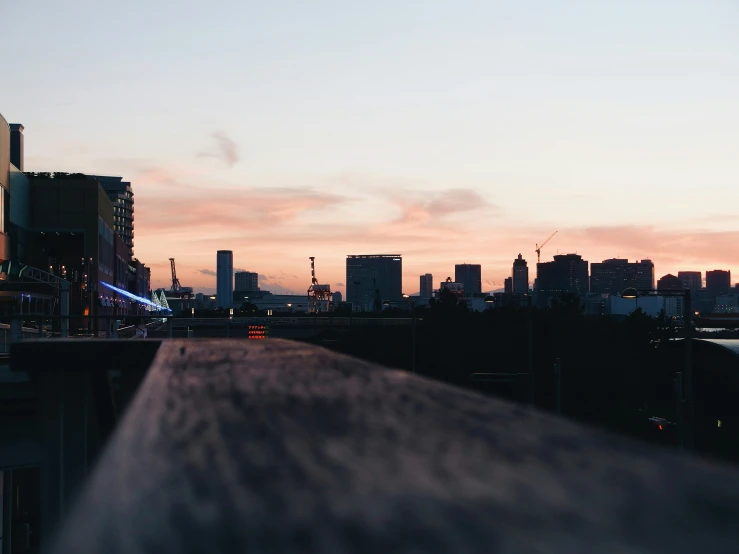 a sunset s of some tall buildings with traffic