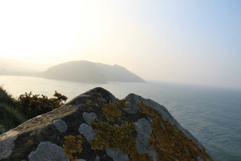 this is a picture of a landscape with water and hills in the background