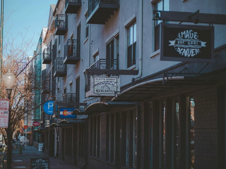 a city street with businesses on the side and signage