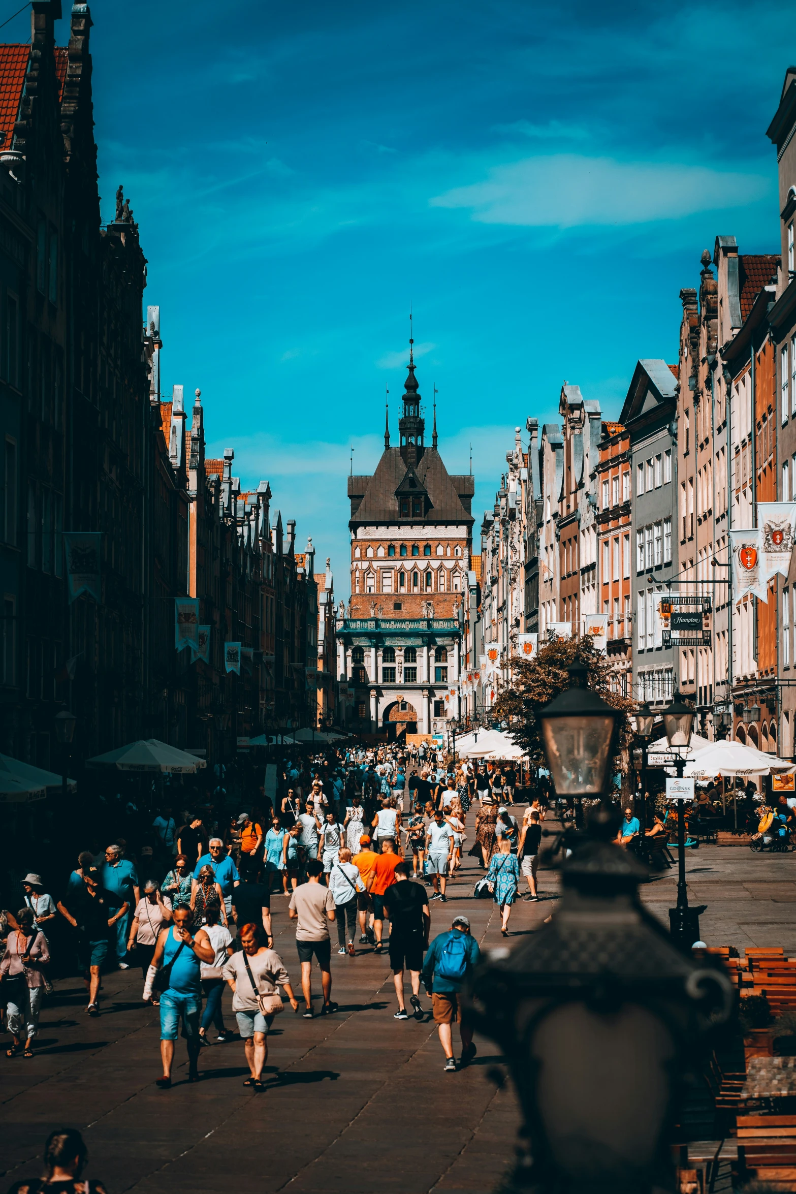 many people are walking through a market place