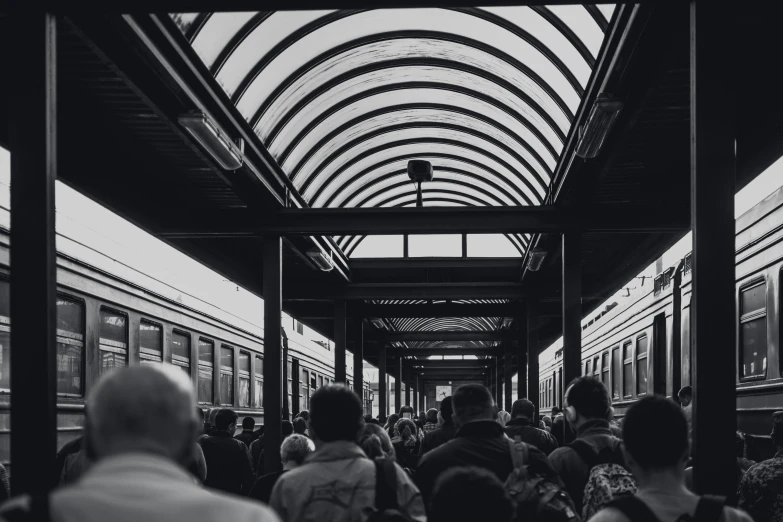 people are walking on a train platform together