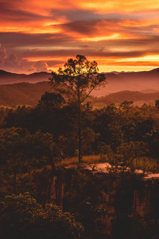 the sunset has a beautiful sky above the valley and mountains