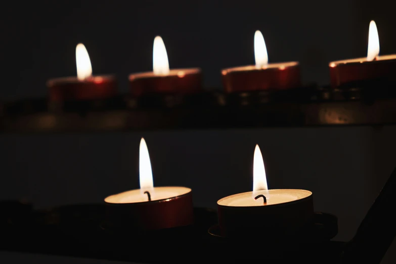 some candles that are on a table in the dark