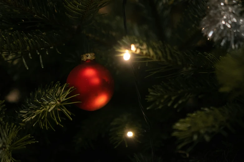 a christmas ornament is on top of a christmas tree