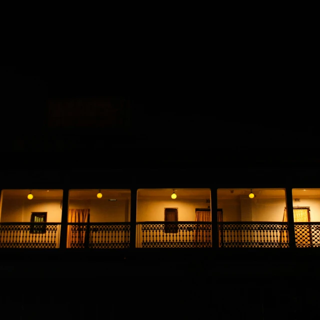 night outside a restaurant with three sets of lighted doors