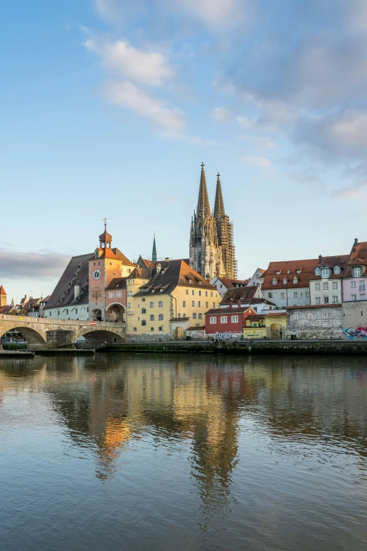 a bridge with buildings and a clock tower in the background