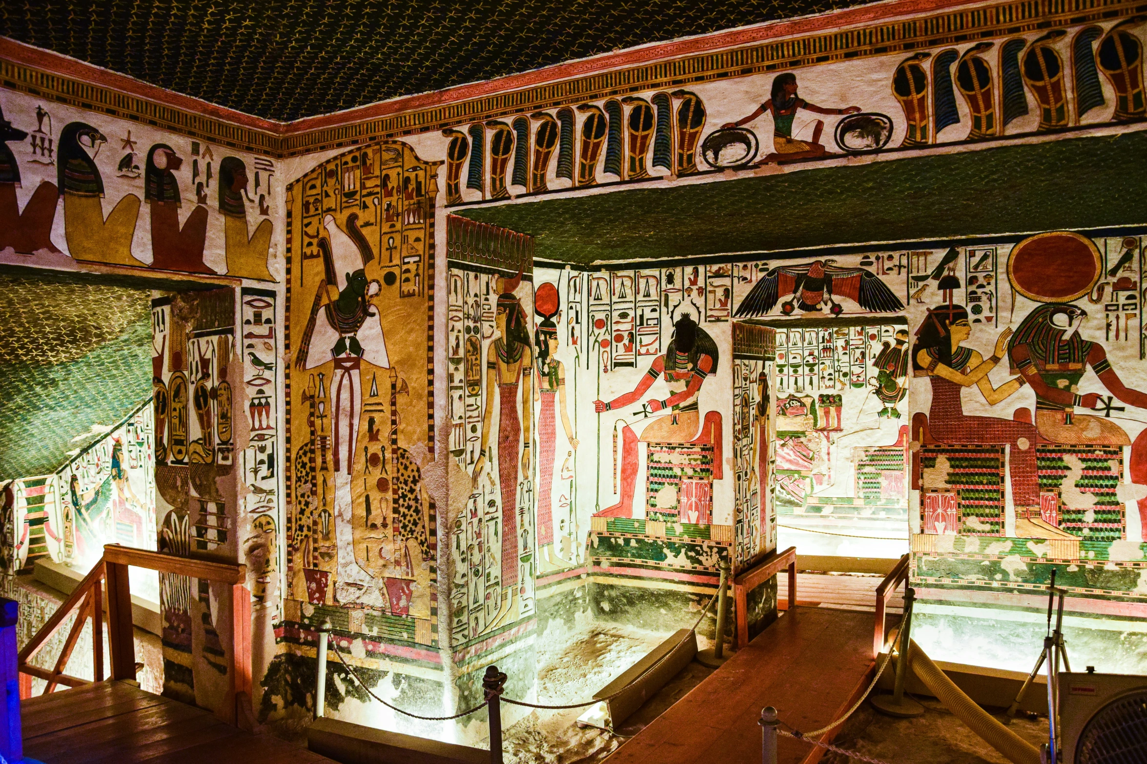 the ceiling of an egyptian themed room that features egyptian wall murals