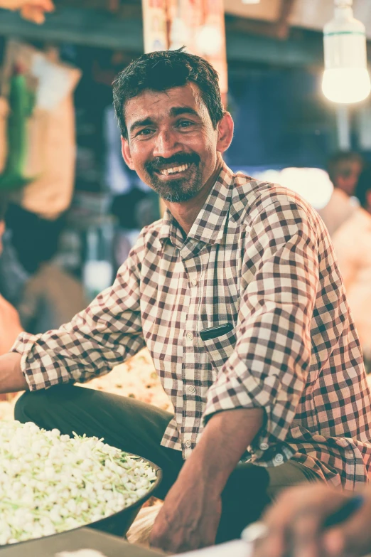 man smiling for the camera, with a bowl of food in front