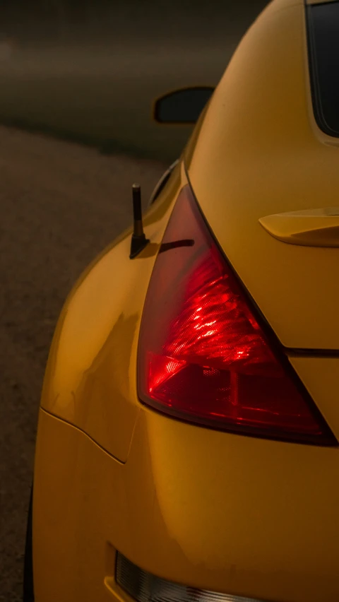 the rear end of a yellow sports car