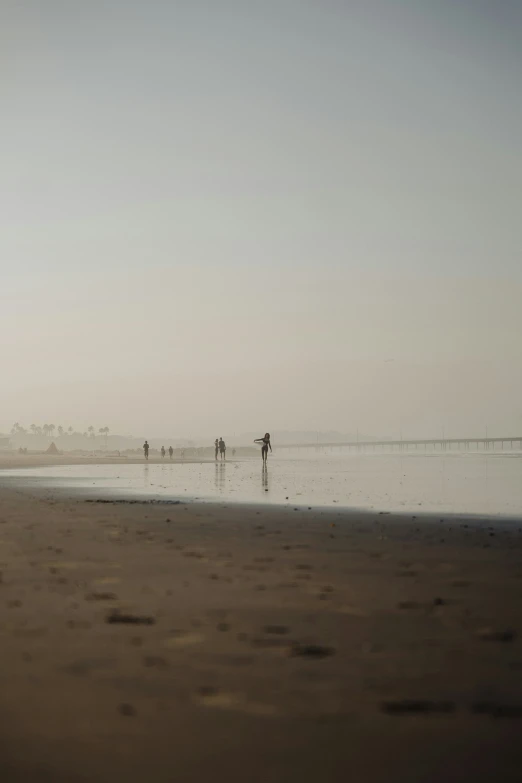 a couple of people walking on top of a beach