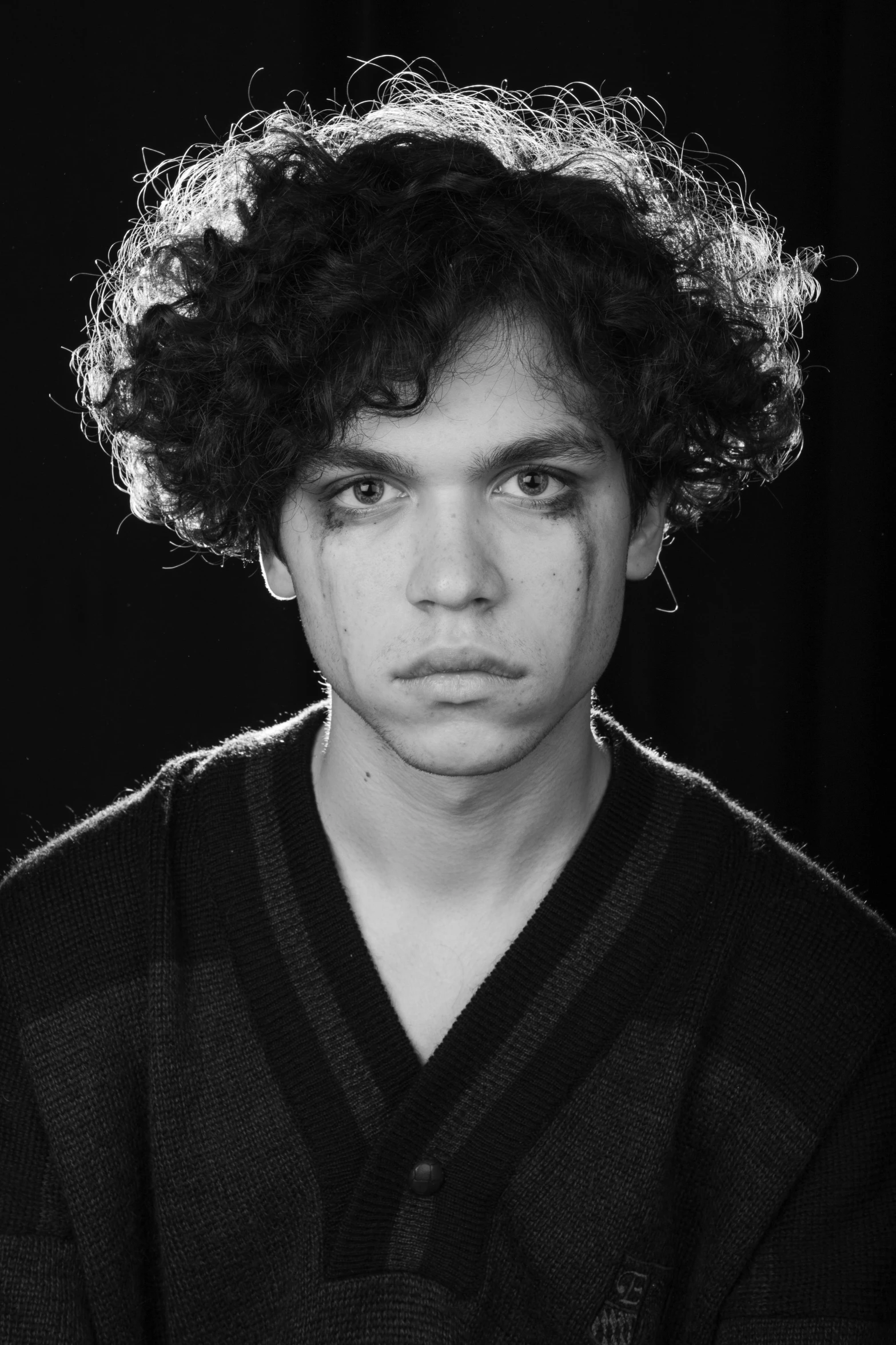 a black and white po of a man with curly hair