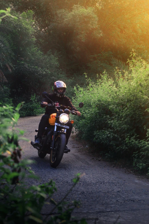 there is a person riding a motorbike down the road