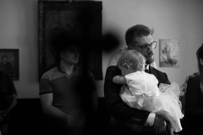 a father holding his daughter as they get ready to walk down the aisle