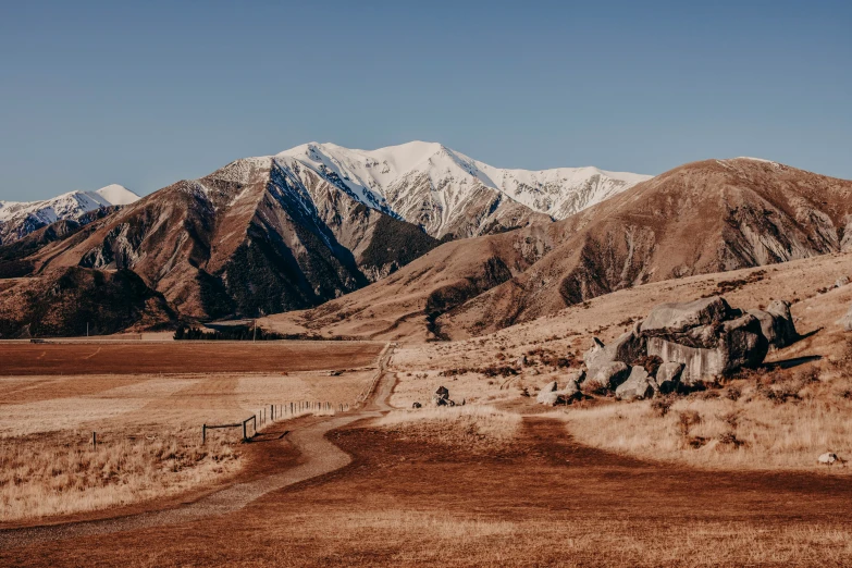 view of mountains with a dirt path next to them