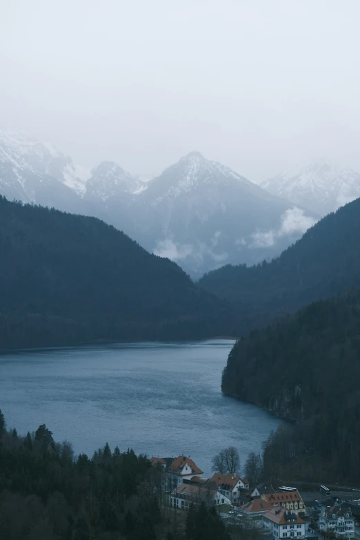 the snow covered mountains overlook a lake