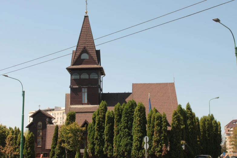 a large building on the corner of a road with trees in front of it