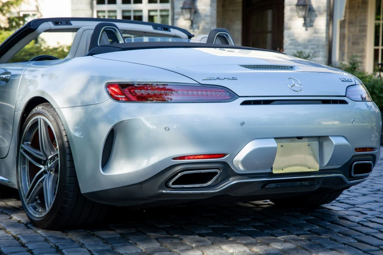 a close up of a sports car on a brick road