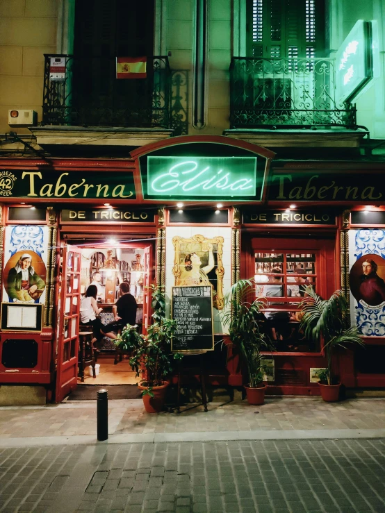 a night view of a restaurant at the corner of a street