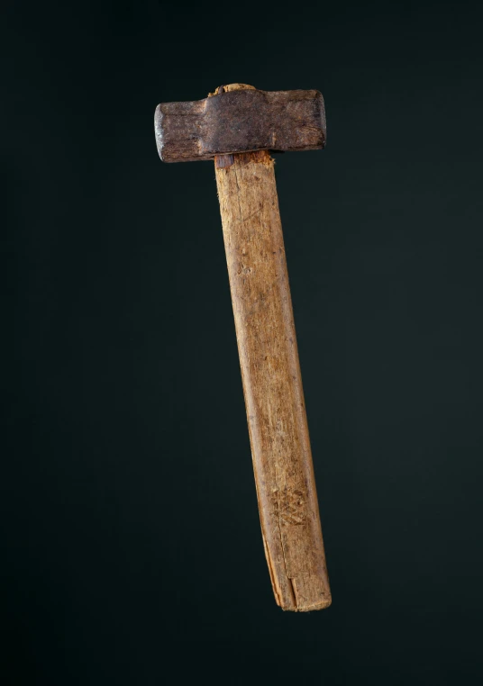 an old hammer that is on a black background