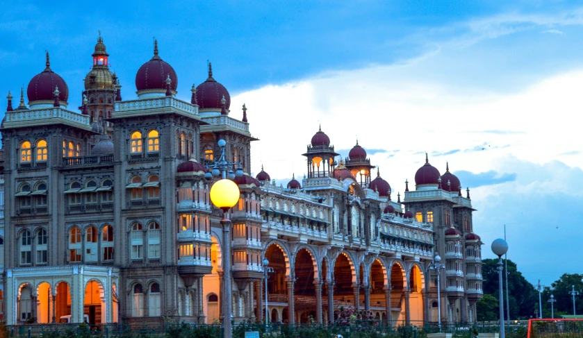 an old victorian style building illuminated up at dusk