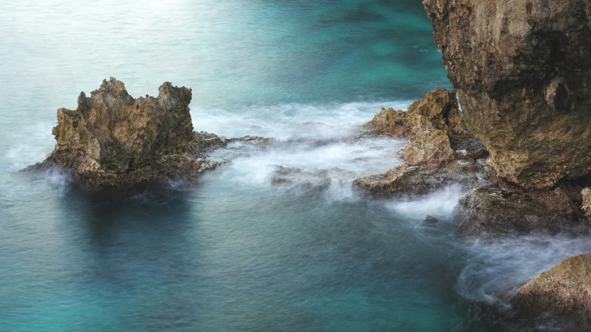 large rocks covered in water near an island