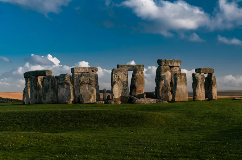 two giraffe standing by some stone monuments