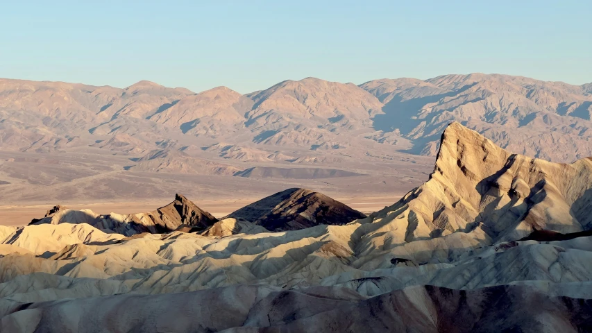 some mountains with a very small blue sky in the distance