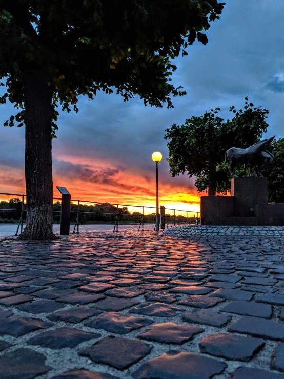 some benches and lights are near a sunset