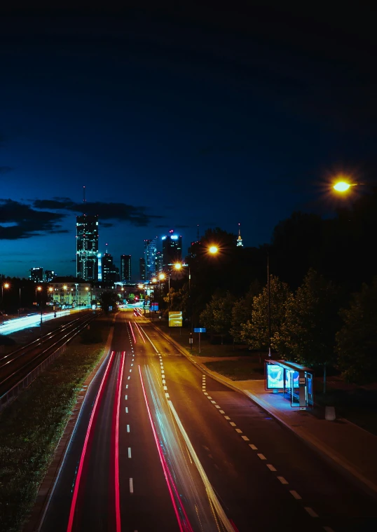 a city at night with light streaks of traffic