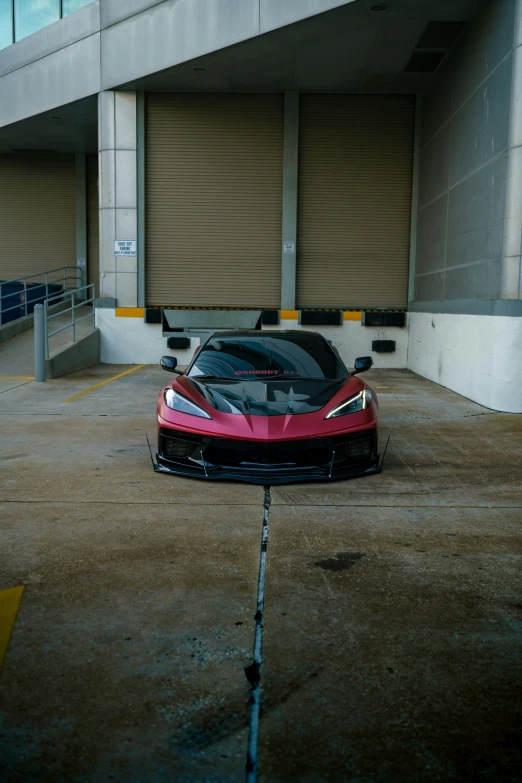 the front end of a black and red car parked in a parking lot