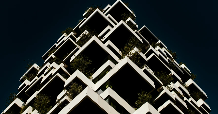 a very tall building with some big plants in the middle