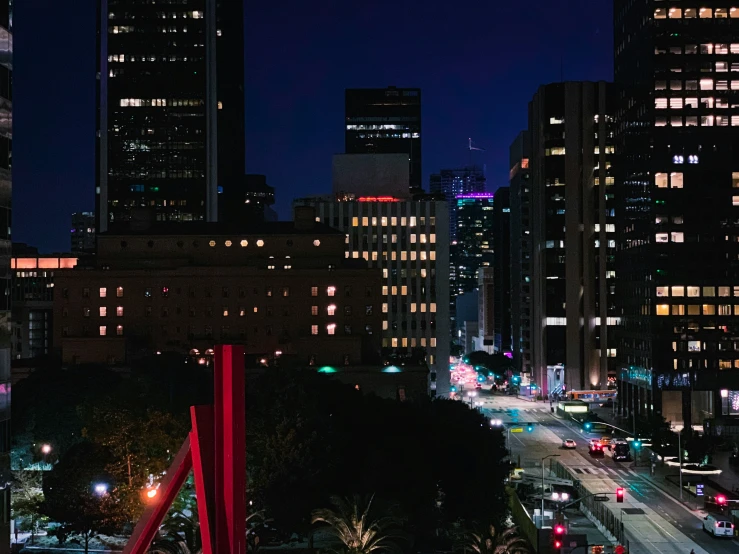 view of skyscrs in a city at night