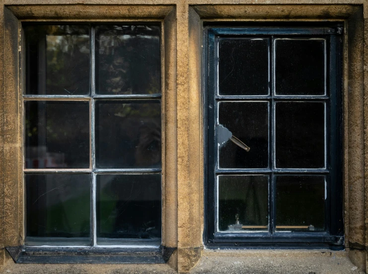 two black and brown windows with one broken