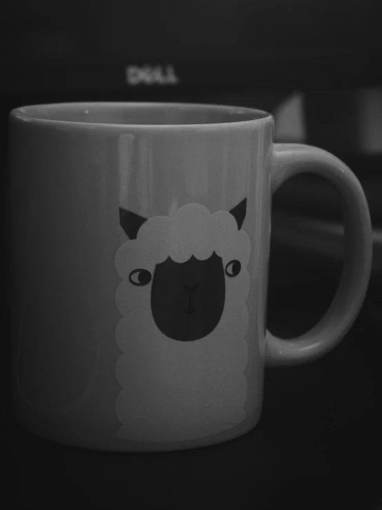 there is a cup with a sheep on it
