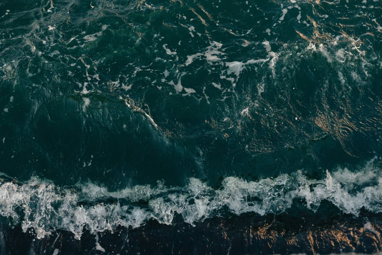 some water waves on the water by a beach