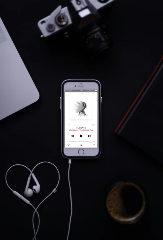 a phone and headphones with a microphone on a desk