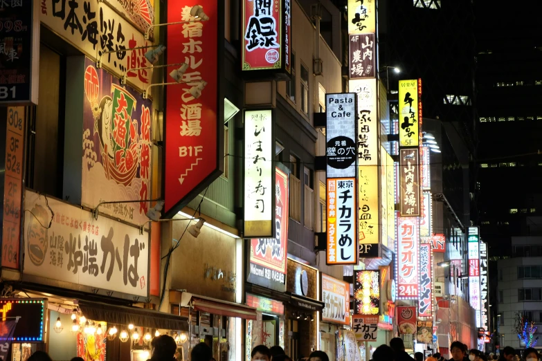 a very crowded asian street lined with restaurants