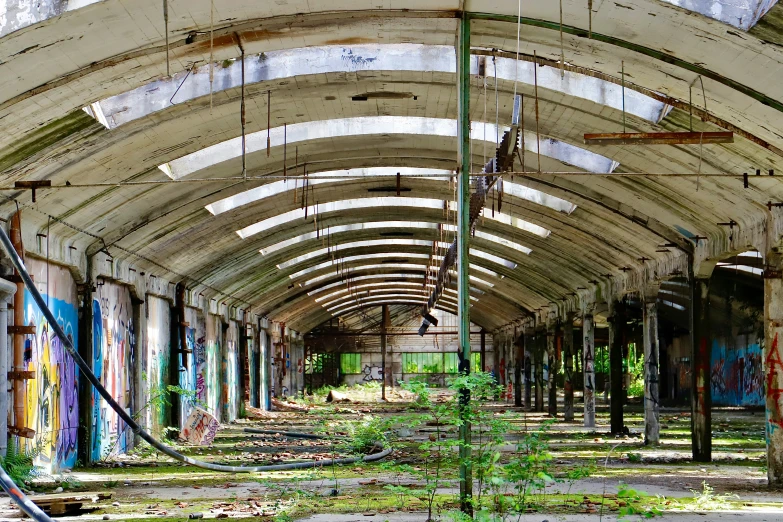 the interior of a building is empty and has graffiti