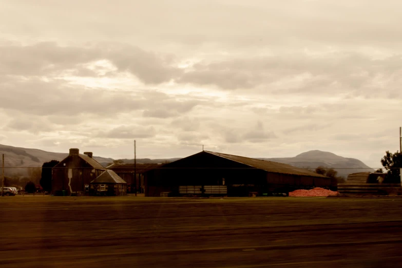 a black barn on an open, mountainous country road