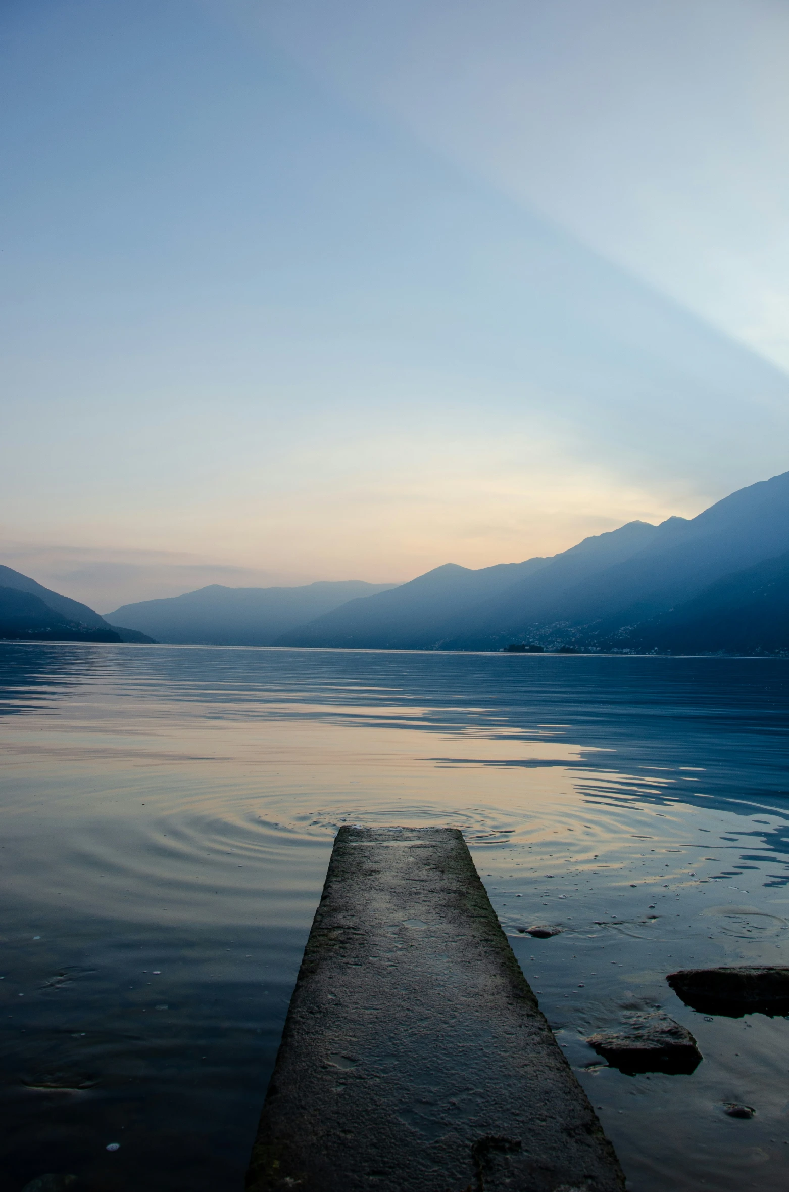 a stone slab sitting on top of a body of water