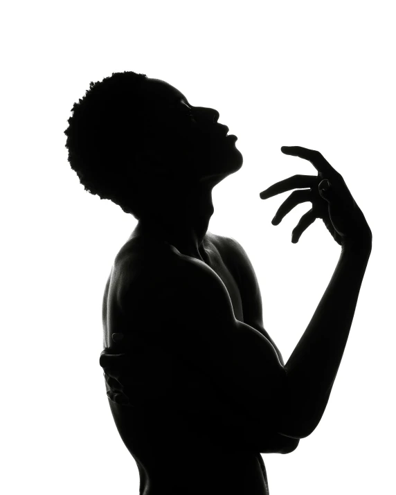 silhouette of woman with arms raised to side