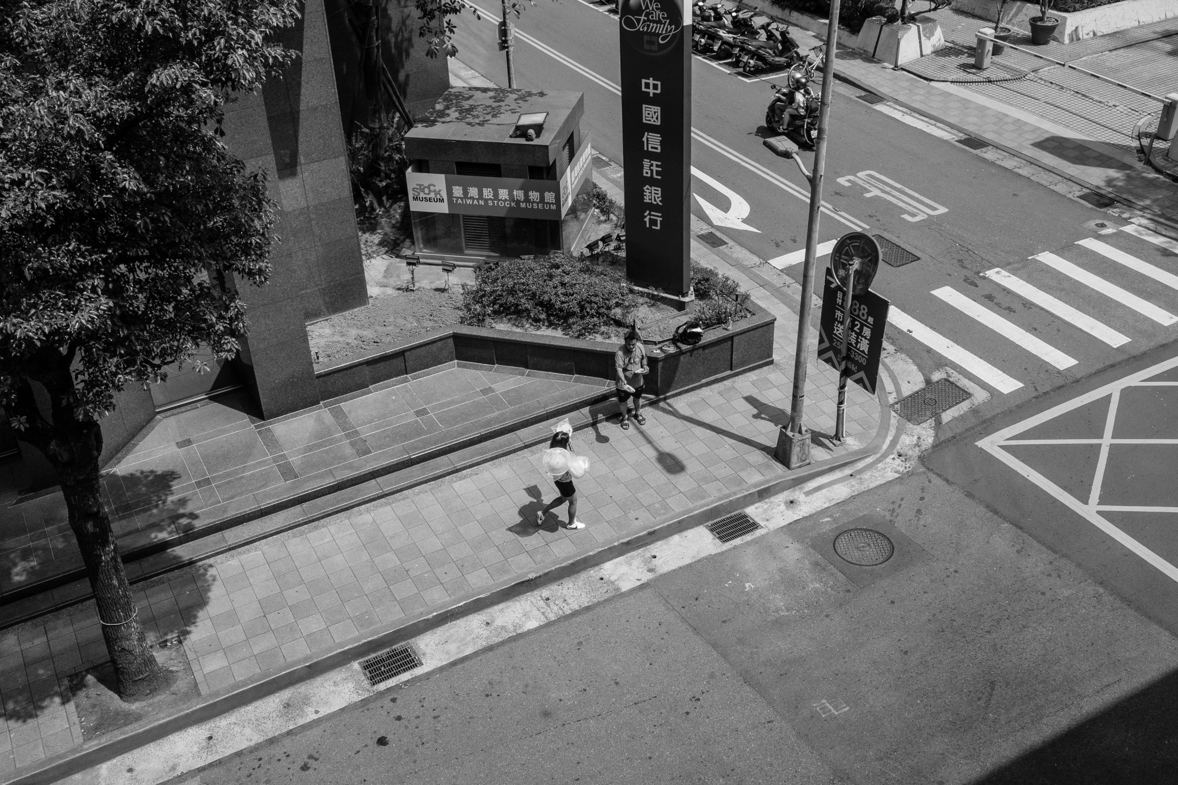 an elevated view of a city intersection with people on the street