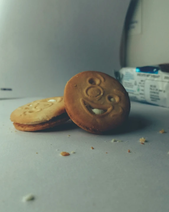 a couple of cookies with a smiley face cut out of it