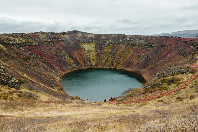 a large crater has a small pond inside